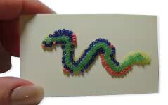 Wax squiggle covered in seed beads